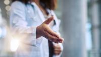 Cropped shot of a female doctor reaching for a handshake